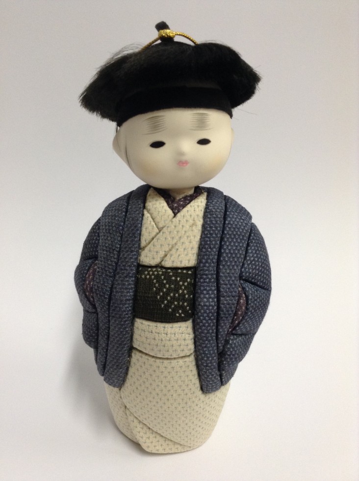 4. A male daruma doll wearing stylised samurai top knot